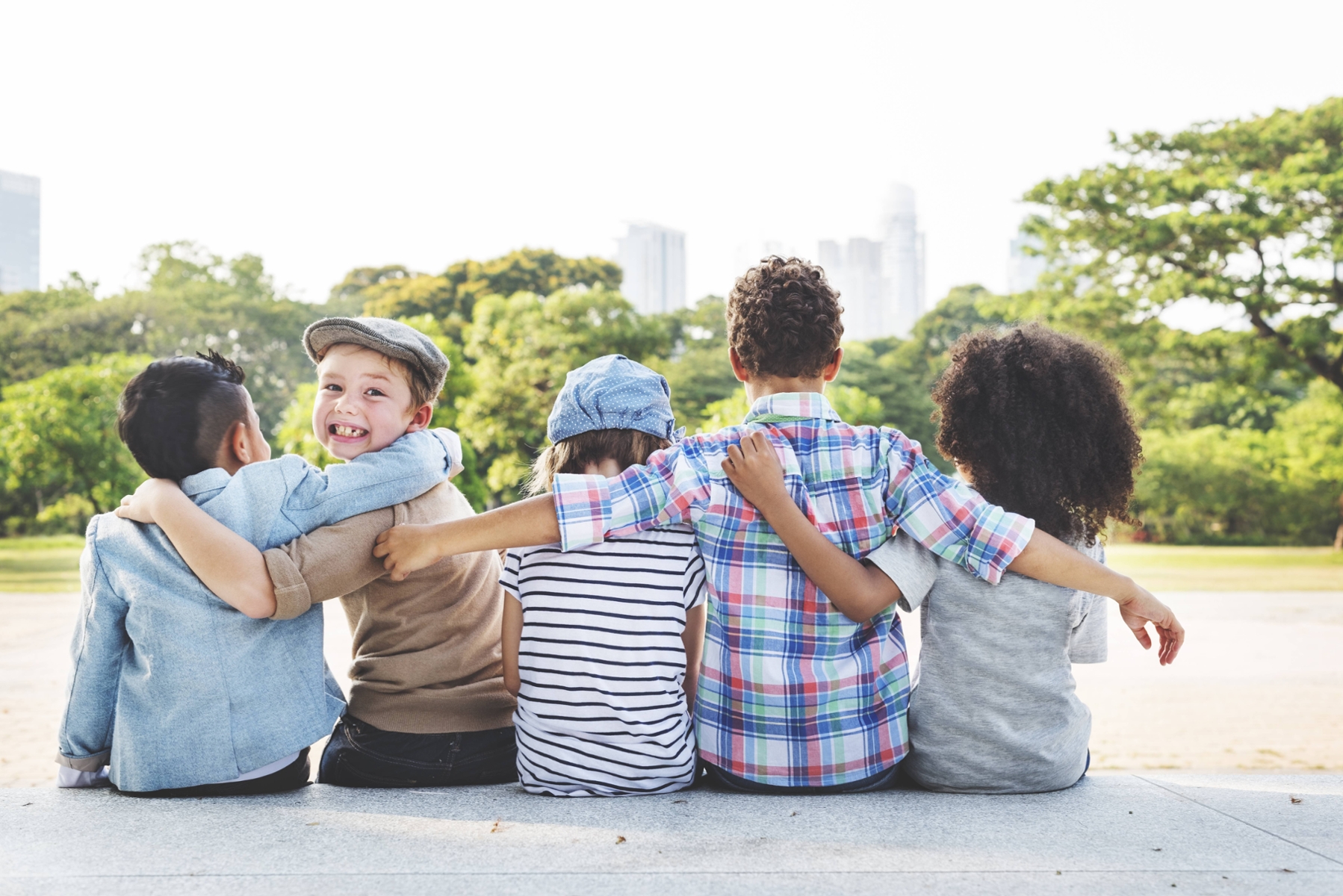group of children hugging outside | children's dentist oakbrook terrace