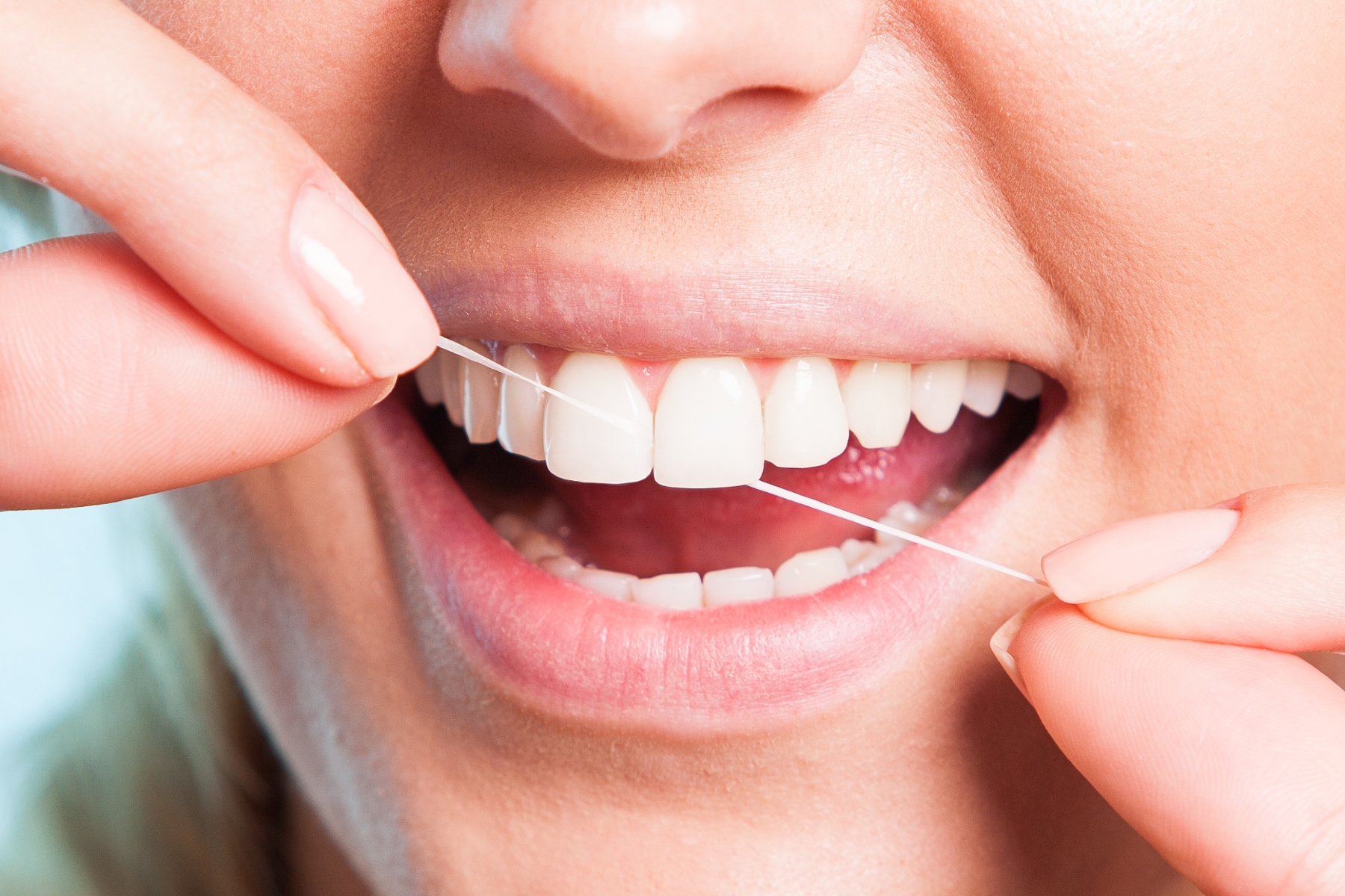 close up of patient using dental floss in oakbrook terrace il