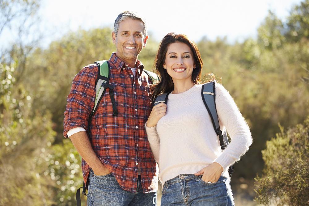 middle aged couple hiking outside | veneers oakbrook terrace il
