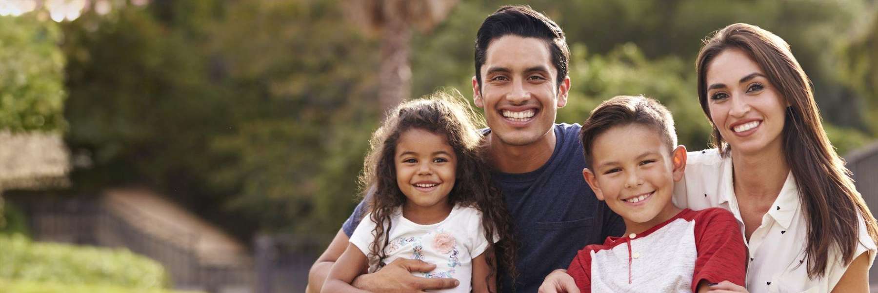 family hugging outside | dentist oakbrook