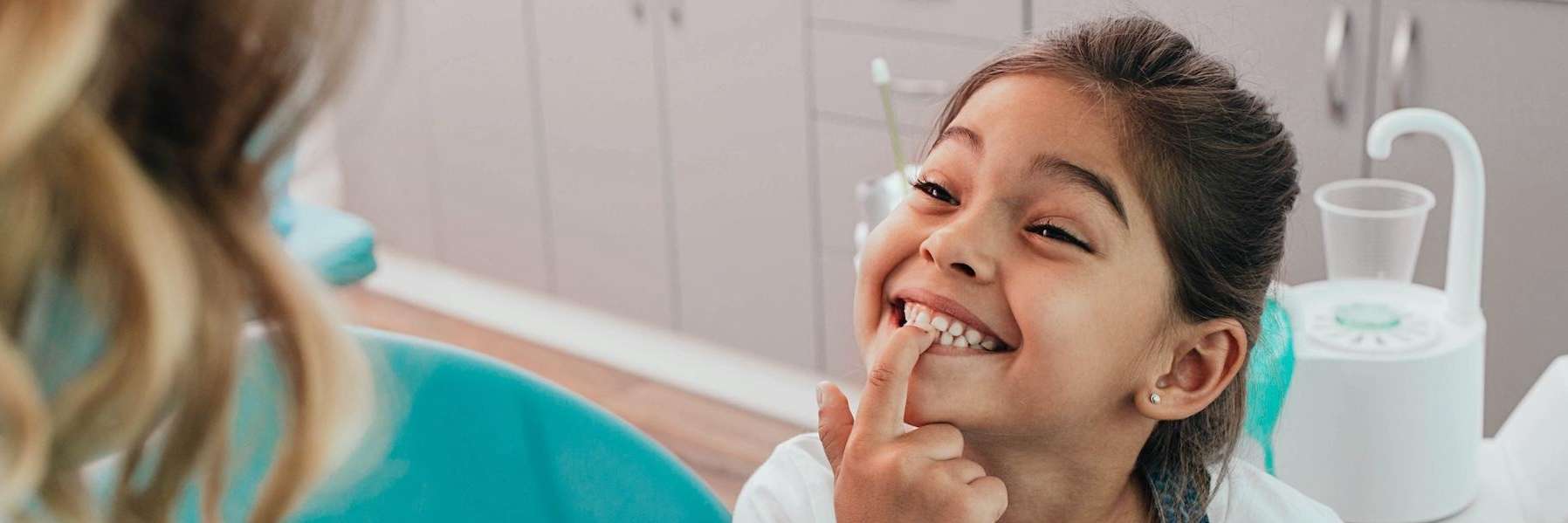 little girl showing missing tooth | dentist oakbrook terrace il