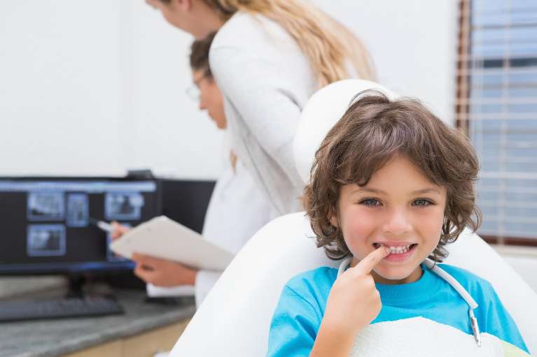 small child sitting in dentist exam chair | children's dentist oakbrook terrace il