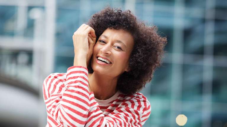 woman in striped shirt smiling | cosmetic dentist oakbrook terrace il
