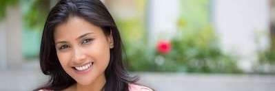 woman in pink shirt smiling | teeth whitening oakbrook terrace il
